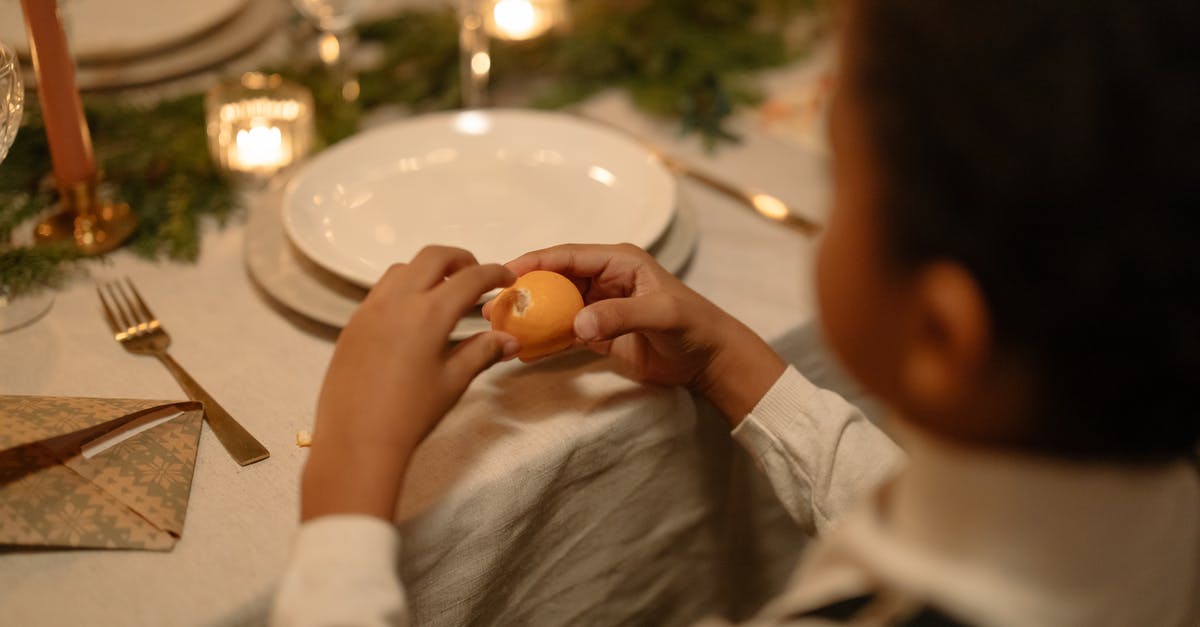 Fruit peeling techniques - A Person Peeling Lemon
