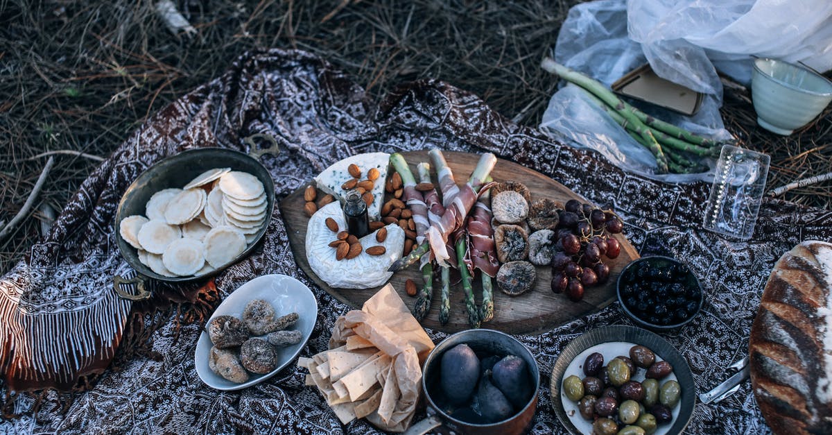 Fruit that has been mistaken as olive fruit? - From above of appetizing homemade bread and cheese placed near fruits and vegetables in bowls and on wooden cutting board for picnic on nature Fruit that has been mistaken as olive fruit? - From above of appetizing homemade bread and cheese placed near fruits and vegetables in bowls and on wooden cutting board for picnic on nature