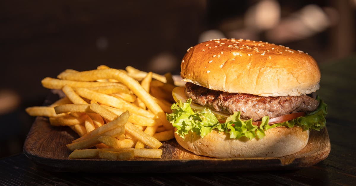 Frying - Straw potatoes in fryer - Plate of Fries and Burger Frying - Straw potatoes in fryer - Plate of Fries and Burger