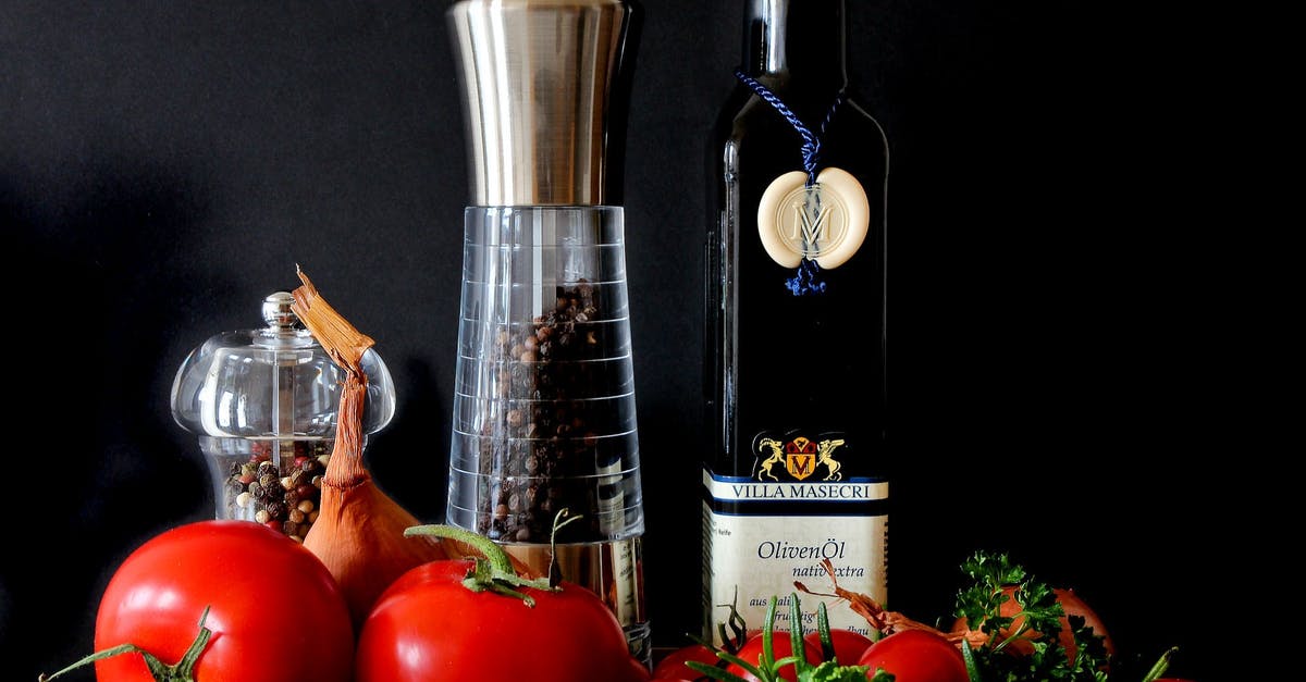 Garlic Infused Oil—Safety - Tomatoes Beside Shakers and Olive Oil Bottle Garlic Infused Oil—Safety - Tomatoes Beside Shakers and Olive Oil Bottle