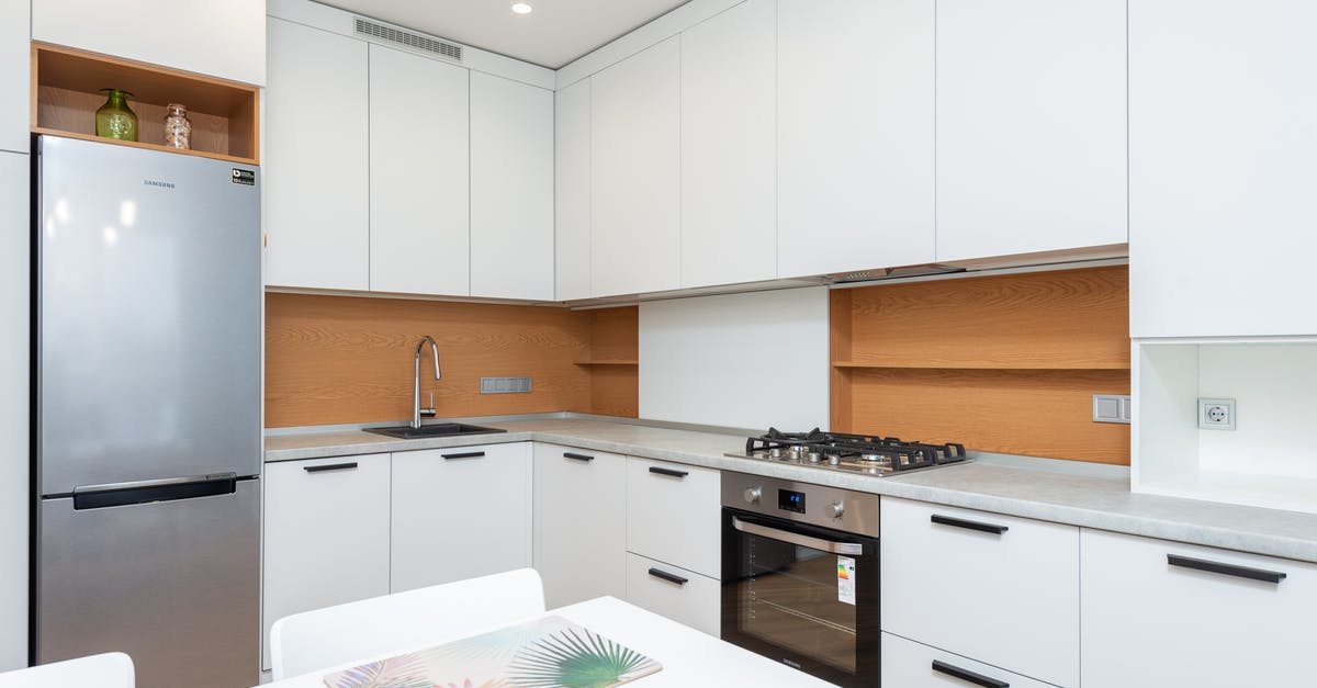 Gas or electric for rack oven in a bakery? - Contemporary kitchen with gas stove and oven against table with placemats and refrigerator reflecting shiny lamps in house Gas or electric for rack oven in a bakery? - Contemporary kitchen with gas stove and oven against table with placemats and refrigerator reflecting shiny lamps in house