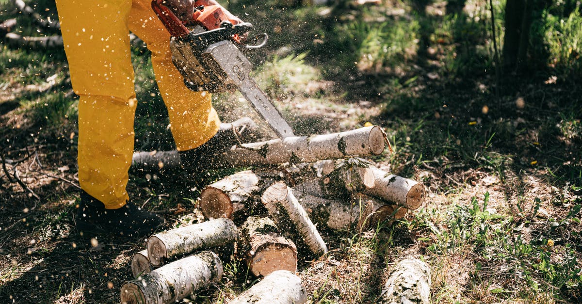 gas range hack for greater power output: does it work? - Lower body of crop anonymous person in yellow trousers lumbering log with gas chain saw in forest on summer day gas range hack for greater power output: does it work? - Lower body of crop anonymous person in yellow trousers lumbering log with gas chain saw in forest on summer day