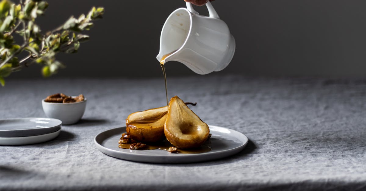 Georgian dessert based on walnuts - Person Pouring Syrup on Sliced Pears