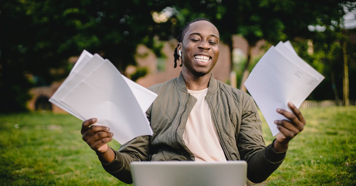 Get Grade A produce? - Student with documents and laptop happy about getting into university