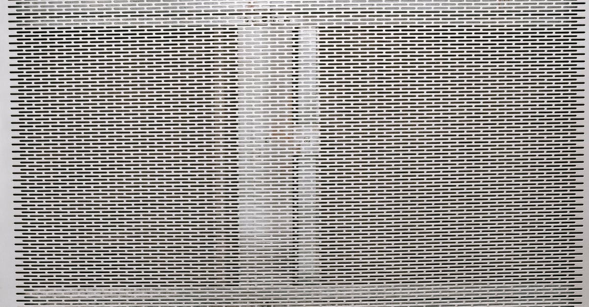 Getting a cast iron skillet surface smooth - Metal gray grill texture with holes Getting a cast iron skillet surface smooth - Metal gray grill texture with holes