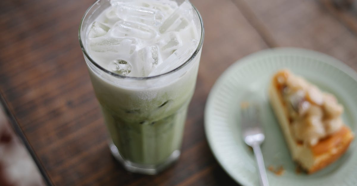 Getting flavor to stick in milk tea - Tasty iced matcha latte served with sweet pie Getting flavor to stick in milk tea - Tasty iced matcha latte served with sweet pie