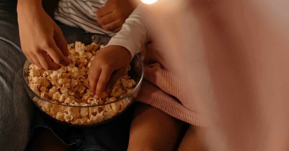 Getting the bowl out of the mold - Photograph of Kid's Hands Getting Popcorn From a Bowl Getting the bowl out of the mold - Photograph of Kid's Hands Getting Popcorn From a Bowl