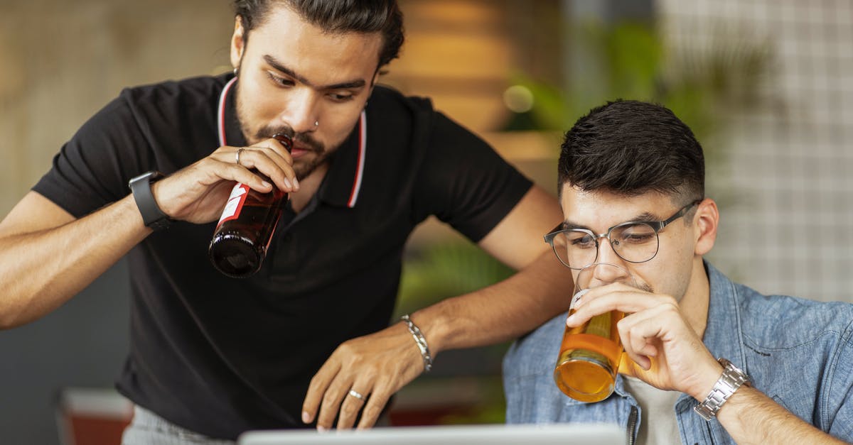 Glass bottle thickness ratings - Men Drinking Beer and Looking at a Laptop Screen Glass bottle thickness ratings - Men Drinking Beer and Looking at a Laptop ScreenÂ