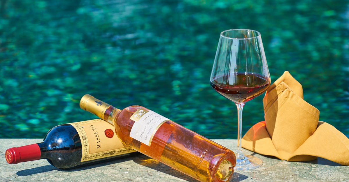 Glass still safe after boil-off? - Two Labeled Bottles Of Wine Beside A Wine Glass By The Pool Glass still safe after boil-off? - Two Labeled Bottles Of Wine Beside A Wine Glass By The Pool