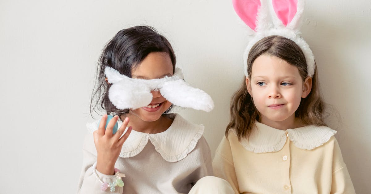 Gnocchi - best fluffy technique - Smiling multiethnic girls playing with bunny ears on light background Gnocchi - best fluffy technique - Smiling multiethnic girls playing with bunny ears on light background