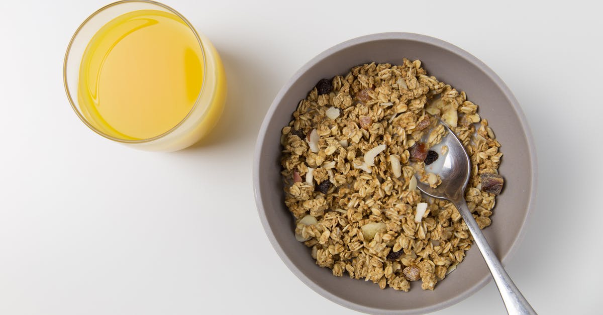 Granola from oat groats - Oats and Nuts in Gray Bowl Granola from oat groats - Oats and Nuts in Gray Bowl