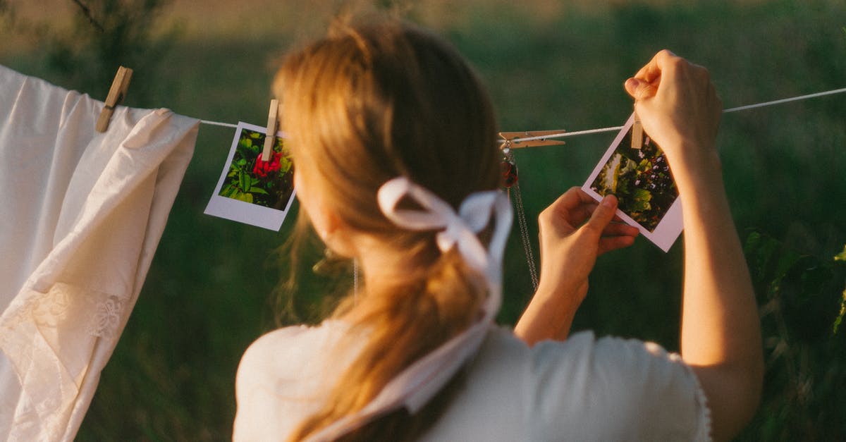 Graphene oxide drying - A Person Hanging Polaroid Photographs on a Clothesline