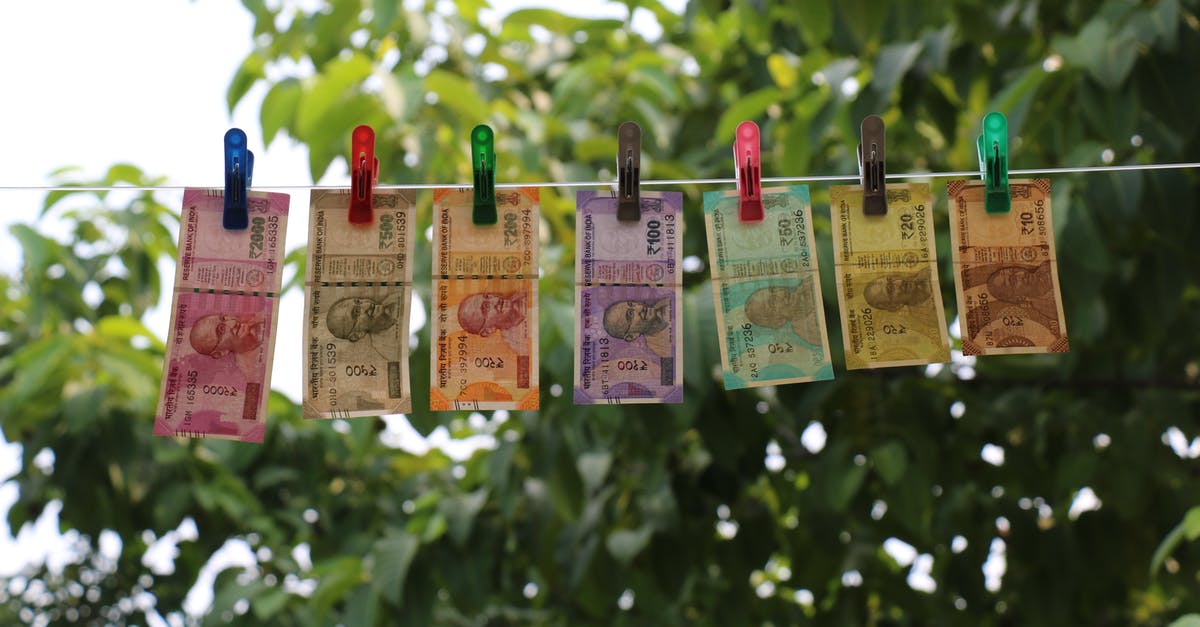 Graphene oxide drying - Seven Indian Rupee Banknotes Hanging from Clothesline on Clothes Pegs