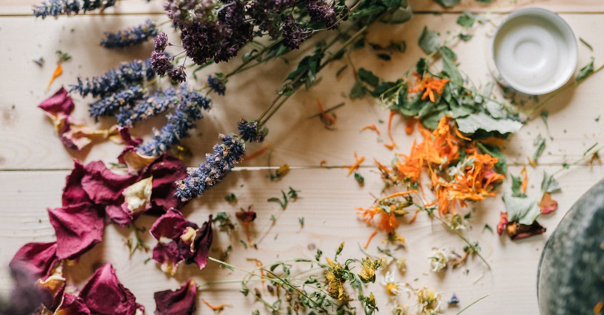 Grinding dried chiles in a mortar and pestle? - Dried flowers and Petals on a Wooden Table