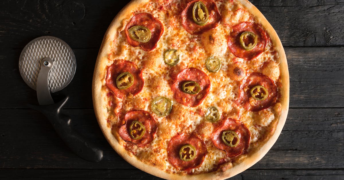 Grinding melted latex off a pizza stone? - Delicious pizza with pepperoni and chili pepper slices Grinding melted latex off a pizza stone? - Delicious pizza with pepperoni and chili pepper slices