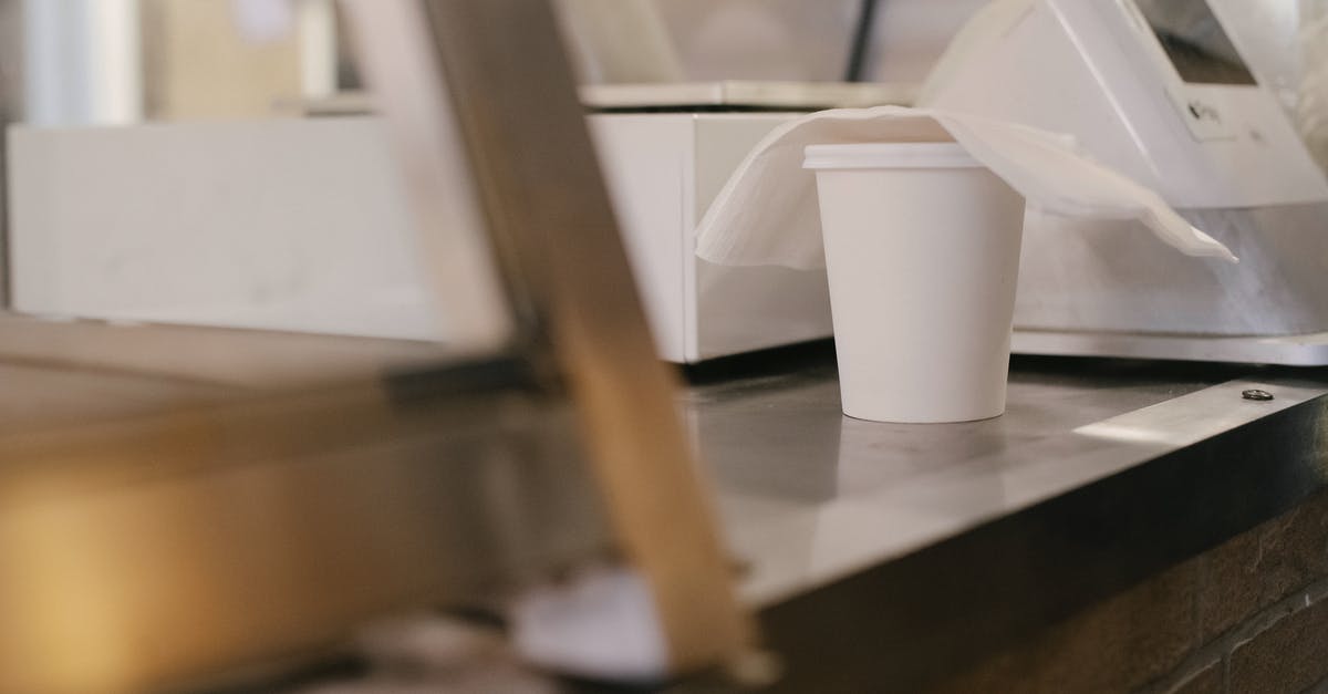 Gritty White Globules in Precooked Grocery Store Sausage? - Paper cup of coffee on counter Gritty White Globules in Precooked Grocery Store Sausage? - Paper cup of coffee on counter