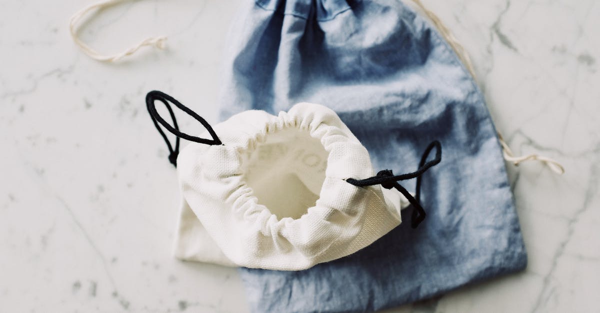 Gritty White Globules in Precooked Grocery Store Sausage? - Top view of composed blue and white modern plain fabric bags on marble table in room Gritty White Globules in Precooked Grocery Store Sausage? - Top view of composed blue and white modern plain fabric bags on marble table in room