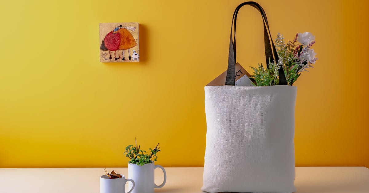 Groceries left out on the counter - Two White Ceramic Mugs and a white bag on Wooden Table Groceries left out on the counter - Two White Ceramic Mugs and a white bag on Wooden Table