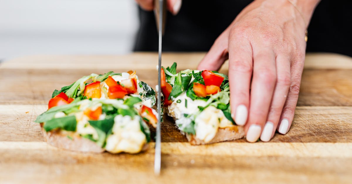 Half and half bread, too salty and no salt? - Hands Cutting Sandwich in Half Half and half bread, too salty and no salt? - Hands Cutting Sandwich in Half