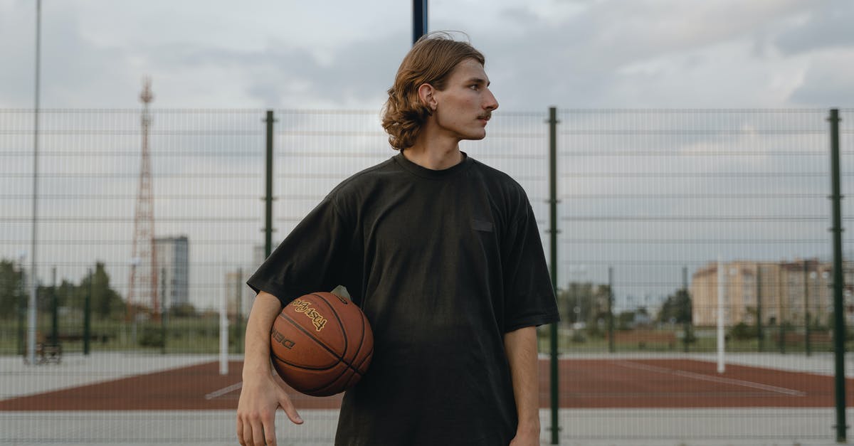 Hamantaschen just wouldn't pinch and hold tight - Man in Black Crew Neck T-shirt with Basketball Between His Arm and Waist