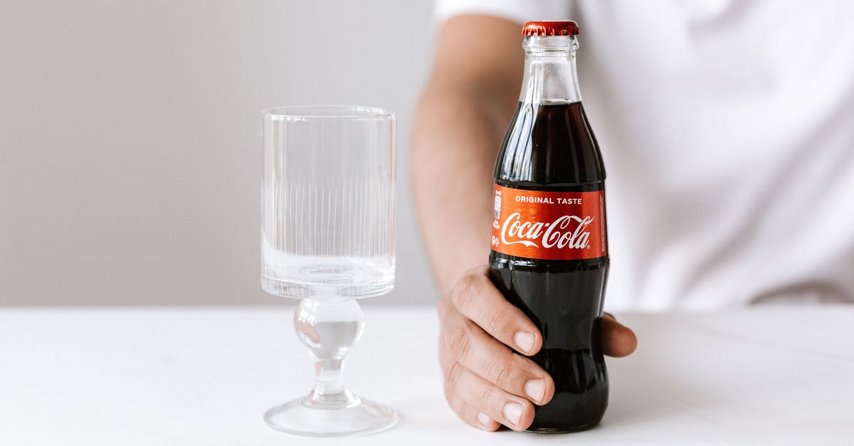 Hamantaschen just wouldn't pinch and hold tight - Crop unrecognizable young guy in white t shirt demonstrating bottle of cold coke