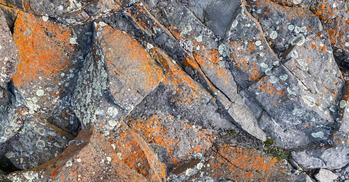 hard crack candy coming out too sticky - Top view of rough natural rock surface with cracks and orange rust as abstract background hard crack candy coming out too sticky - Top view of rough natural rock surface with cracks and orange rust as abstract background