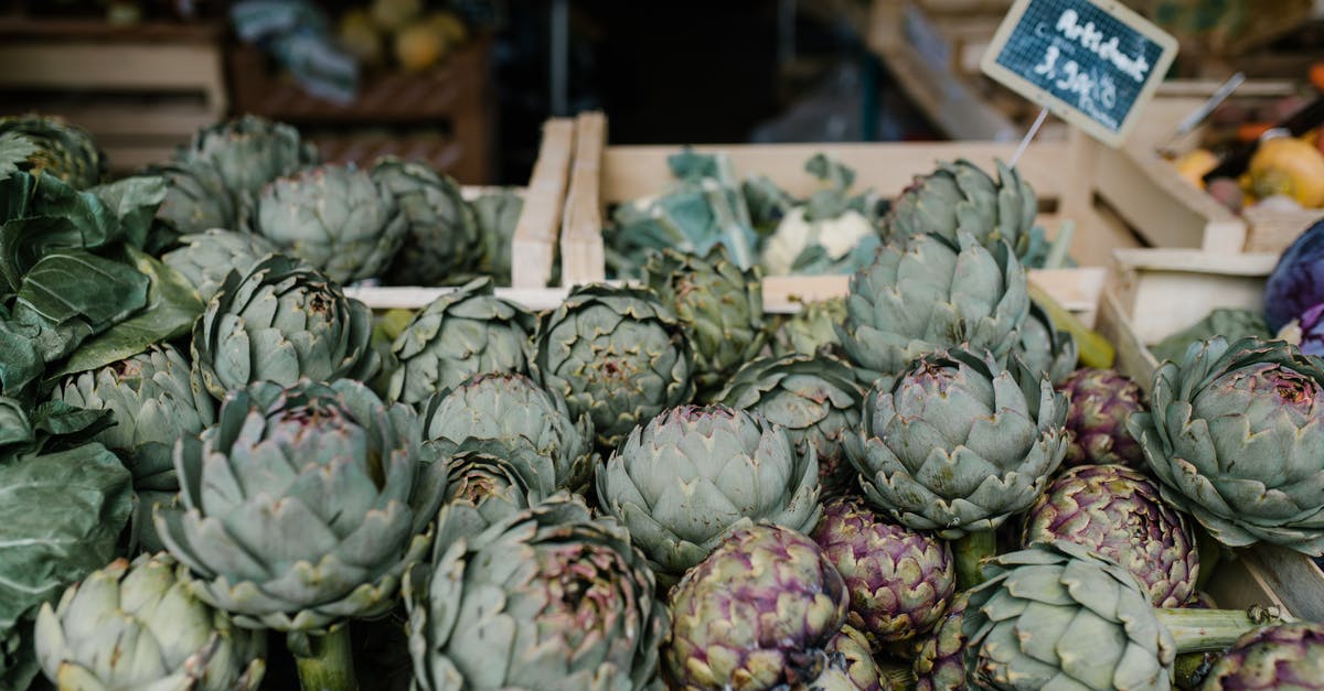 Harshuf -- Artichoke Stalks - Ripe artichokes in boxes in market Harshuf -- Artichoke Stalks - Ripe artichokes in boxes in market