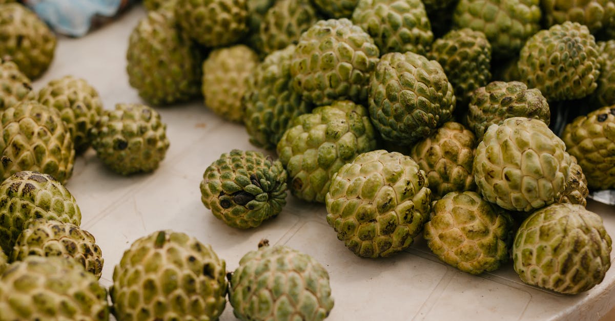 Harshuf -- Artichoke Stalks - From above of stack of fresh ripe exotic globe artichokes placed on table in countryside Harshuf -- Artichoke Stalks - From above of stack of fresh ripe exotic globe artichokes placed on table in countryside