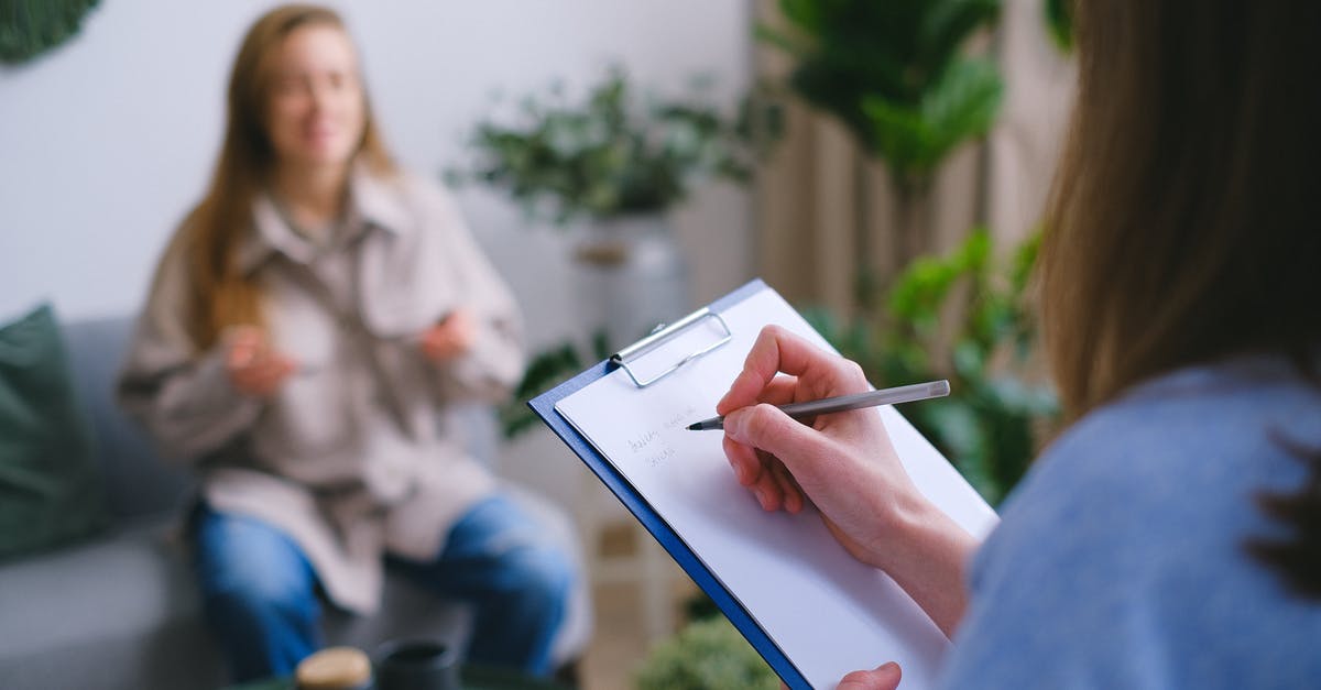 Help - Thawed frozen Lasagne issues [duplicate] - Unrecognizable professional female psychologist writing on clipboard while sitting against client on blurred background during psychotherapy session in light office