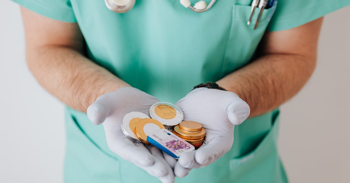 Help making cotton candy - clumps and is wet? - Unrecognizable medical worker demonstrating money wearing medicine form standing near white wall in hospital while working in day of salary