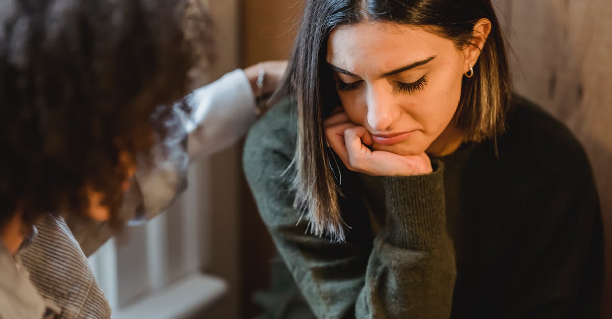 Help with friend with many allergies - Crop woman tapping shoulder and comforting upset female friend while sitting at home together Help with friend with many allergies - Crop woman tapping shoulder and comforting upset female friend while sitting at home together