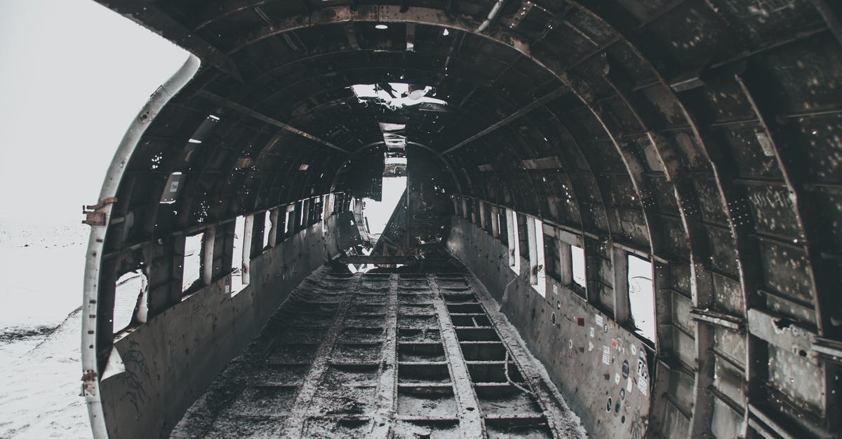 Hole inside my one inch steak - Aged rusty aircraft interior on snowy terrain after disaster Hole inside my one inch steak - Aged rusty aircraft interior on snowy terrain after disaster