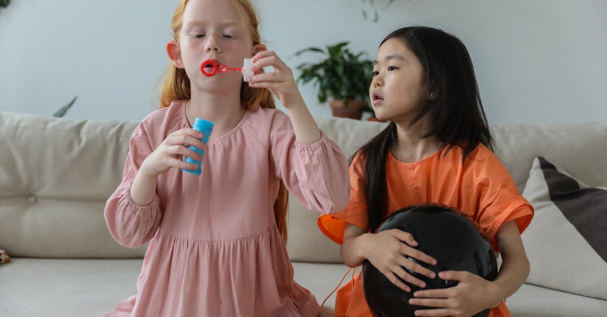 Home made ranch dressing has bubbles. Is it bad? - Adorable little redhead girl in stylish dress blowing soap bubbles while playing with cute Asian girlfriend holding black balloon sitting on sofa at home Home made ranch dressing has bubbles. Is it bad? - Adorable little redhead girl in stylish dress blowing soap bubbles while playing with cute Asian girlfriend holding black balloon sitting on sofa at home