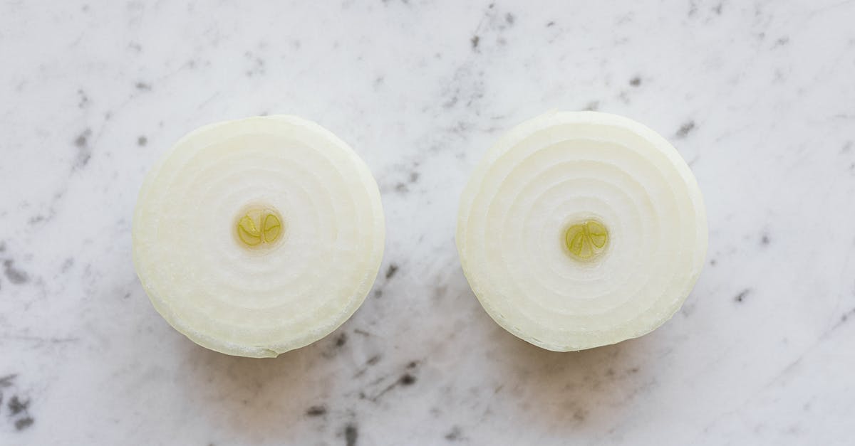 Homemade Coconut Yogurt Turned Yellow on Top Overnight - Top view of raw peeled aromatic onion cut into halves and placed on white marble tabletop Homemade Coconut Yogurt Turned Yellow on Top Overnight - Top view of raw peeled aromatic onion cut into halves and placed on white marble tabletop