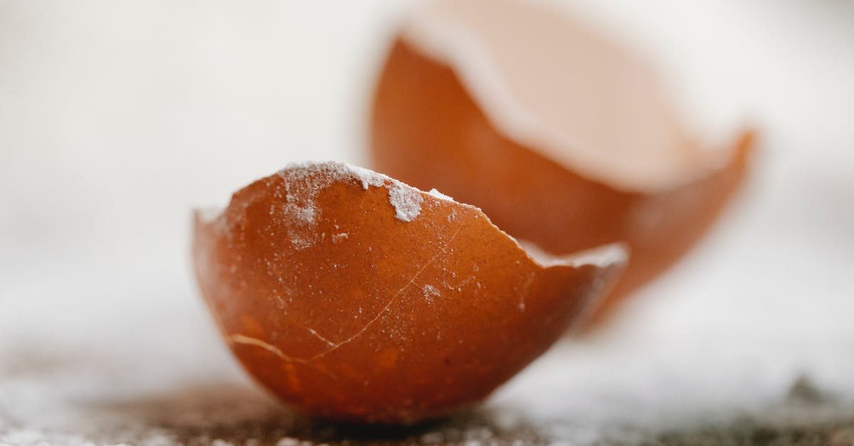Homemade powdered jello recipe - Closeup of broken eggshell placed on table with scattered flour in kitchen for cooking Homemade powdered jello recipe - Closeup of broken eggshell placed on table with scattered flour in kitchen for cooking
