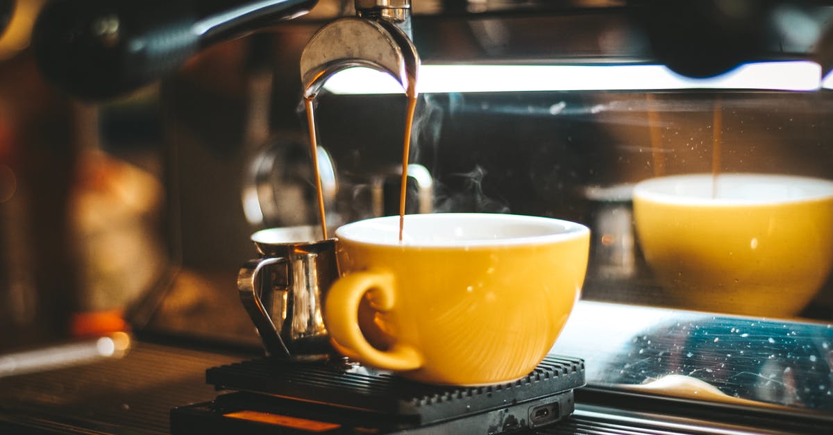 Hot cups and dishes - Espresso Machine Dispensing on Two Mugs Hot cups and dishes - Espresso Machine Dispensing on Two Mugs