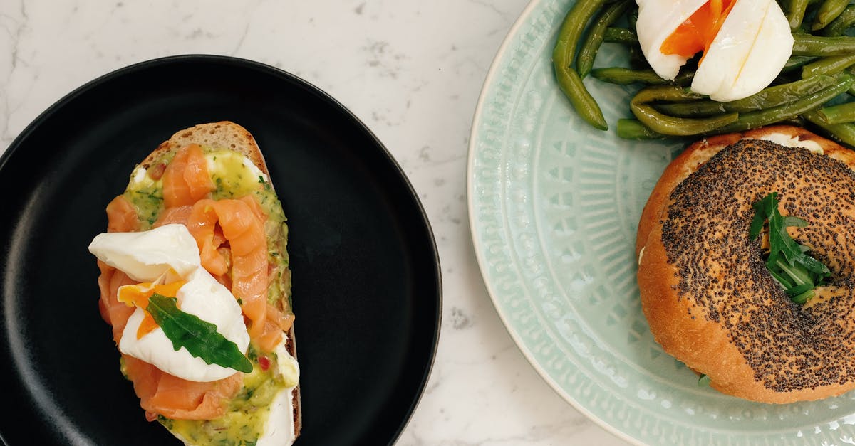 Hot Smoked Salmon on Big Green Egg - Ceramic plates with tasty burger with asparagus and poached egg and toast with fish served on white marble table in modern kitchen