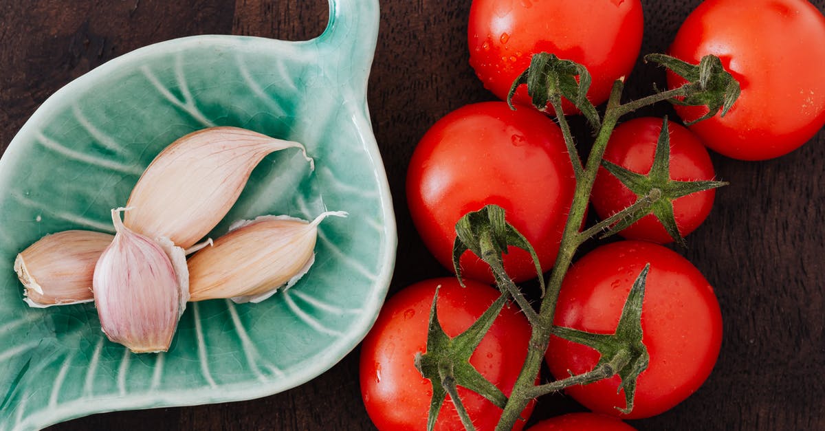 Hours for bacteria to form on raw steak [duplicate] - Tomatoes and plate of cloves on table