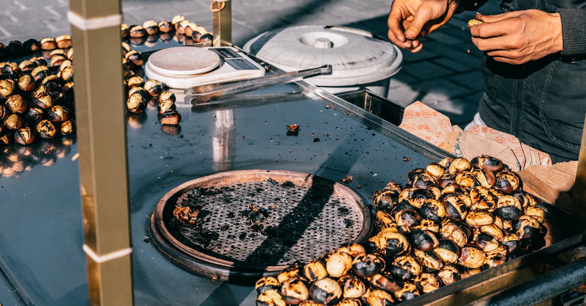How accurate are kitchen scales? - Crop man preparing delicious chestnuts on street How accurate are kitchen scales? - Crop man preparing delicious chestnuts on street