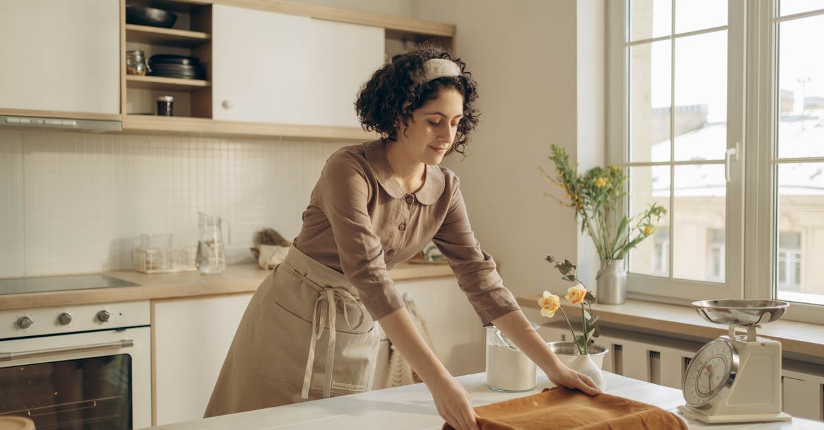 How accurate are kitchen scales? - Woman in Brown Long Sleeves Shirt Getting the Microwavable Pan on the Table How accurate are kitchen scales? - Woman in Brown Long Sleeves Shirt Getting the Microwavable Pan on the Table