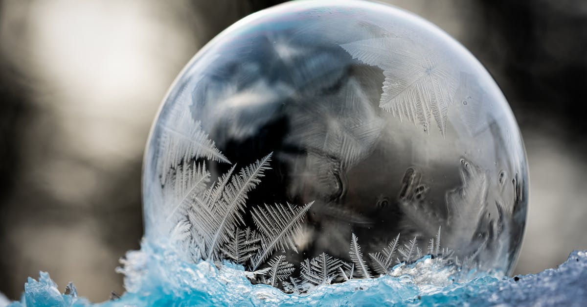 How are chemical leaveners affected by moisture and cool temperature? - Frozen clean transparent bubble with patterns on ice in winter forest on blurred background How are chemical leaveners affected by moisture and cool temperature? - Frozen clean transparent bubble with patterns on ice in winter forest on blurred background