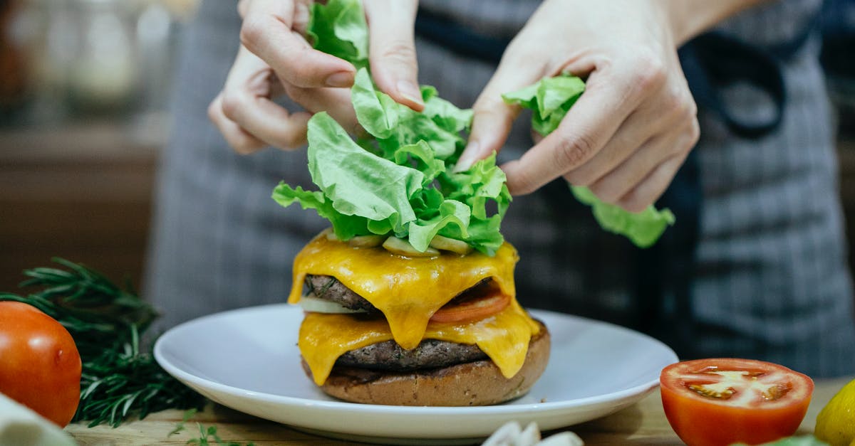 How can I add meat into a completed tomato sauce? - Crop woman cooking burger at table How can I add meat into a completed tomato sauce? - Crop woman cooking burger at table