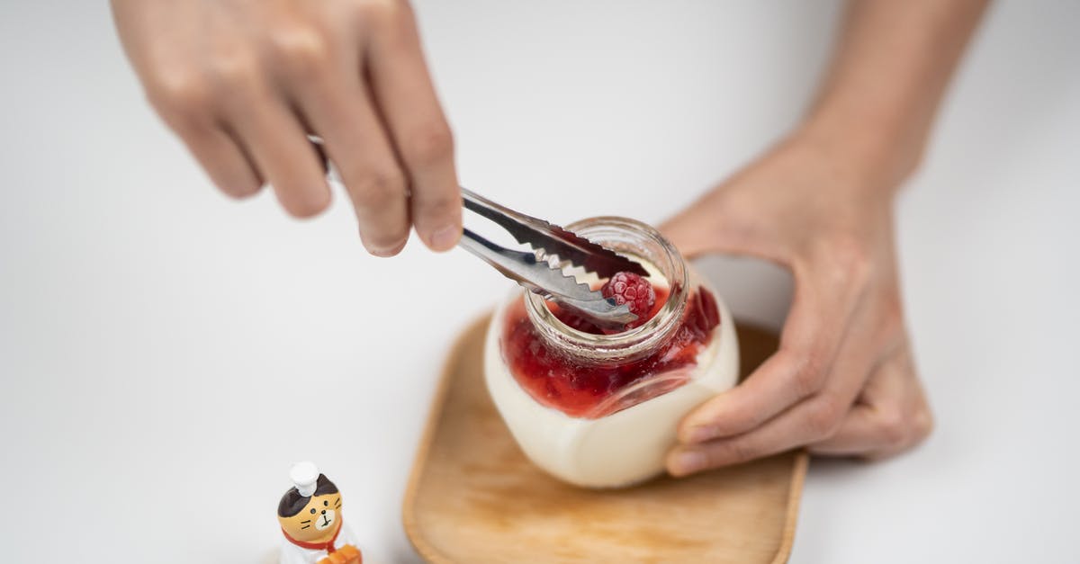 How can I add yogurt to a quickbread recipe? - From above crop anonymous person adding organic ripe raspberries into jar with homemade tasty yogurt placed on white table near funny cat statuette How can I add yogurt to a quickbread recipe? - From above crop anonymous person adding organic ripe raspberries into jar with homemade tasty yogurt placed on white table near funny cat statuette