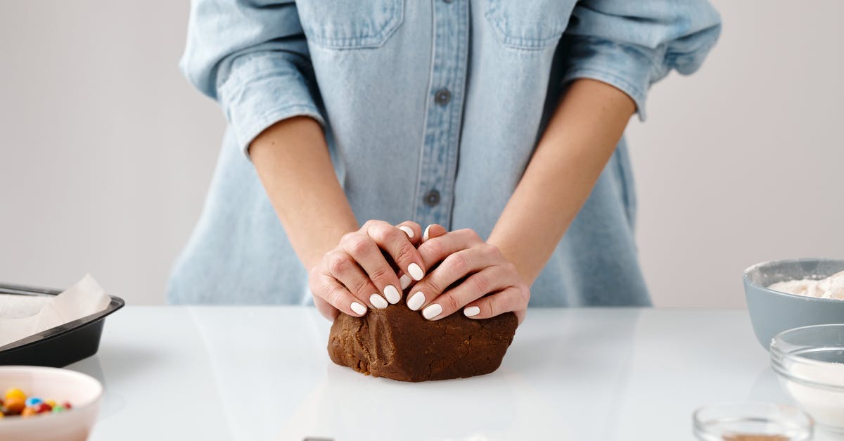 How can I avoid chocolate truffle mix curdling? - Person Kneading a Chocolate Dough by Hands How can I avoid chocolate truffle mix curdling? - Person Kneading a Chocolate Dough by Hands