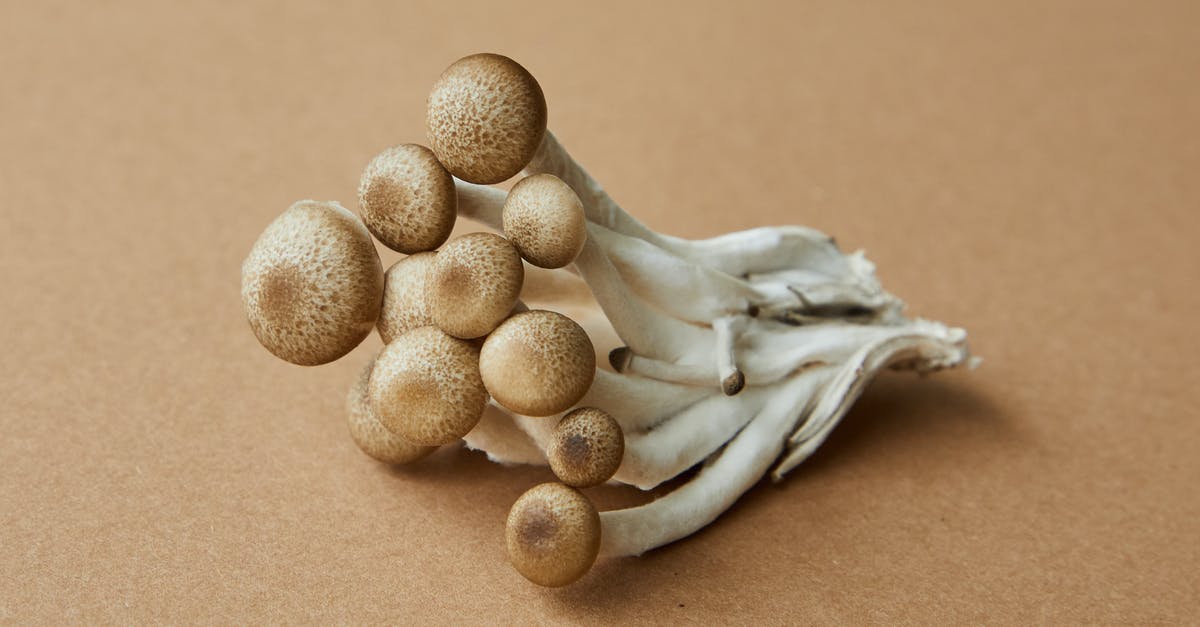 How can I avoid from turning mushrooms brown while freezing it? - High angle of fresh uncooked edible light brown shimeji mushrooms on brown background How can I avoid from turning mushrooms brown while freezing it? - High angle of fresh uncooked edible light brown shimeji mushrooms on brown background
