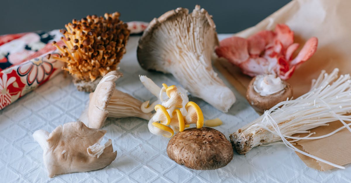 How can I avoid from turning mushrooms brown while freezing it? - From above of various exotic mushrooms placed on textured white table on green background How can I avoid from turning mushrooms brown while freezing it? - From above of various exotic mushrooms placed on textured white table on green background