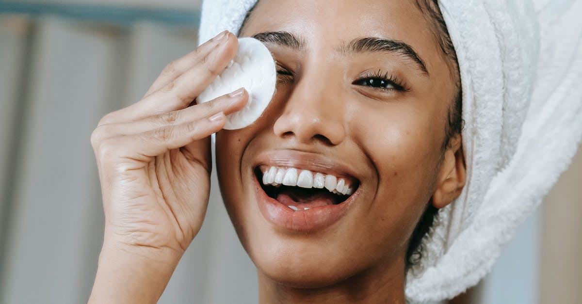 How can I BBQ everyday without the cleaning? - Cheerful ethnic female wrapped in towel turban moisturizing face with lotion while smiling happily How can I BBQ everyday without the cleaning? - Cheerful ethnic female wrapped in towel turban moisturizing face with lotion while smiling happily