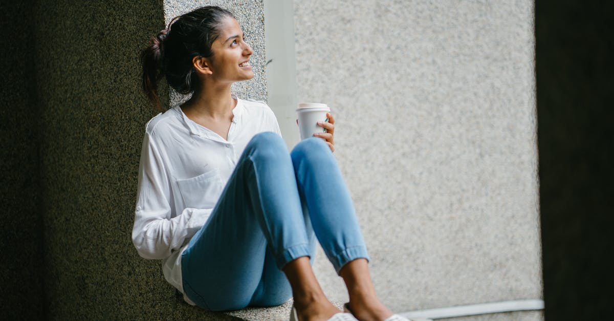How can I chill ice coffee quickly? - Woman posing. Wearing White Dress Shirt Sitting on Window How can I chill ice coffee quickly? - Woman posing. Wearing White Dress Shirt Sitting on Window