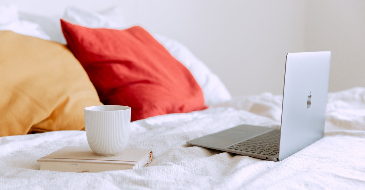 How can I chill ice coffee quickly? - Laptop and cup of coffee on notepad near pillows on bed at daytime How can I chill ice coffee quickly? - Laptop and cup of coffee on notepad near pillows on bed at daytime