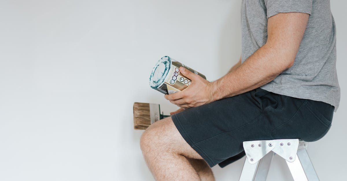 How can I clean chia seeds? - Side view of crop anonymous male with professional brush and can of paint near white wall in house How can I clean chia seeds? - Side view of crop anonymous male with professional brush and can of paint near white wall in house